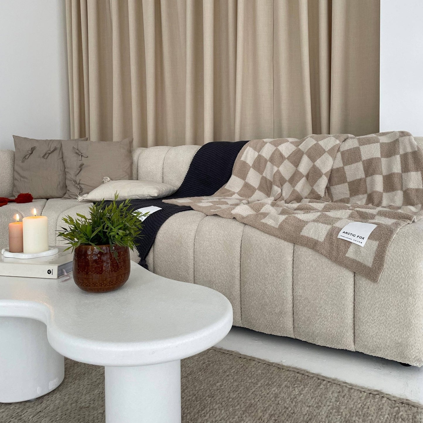 beige and white chequered blanket over a cream sofa