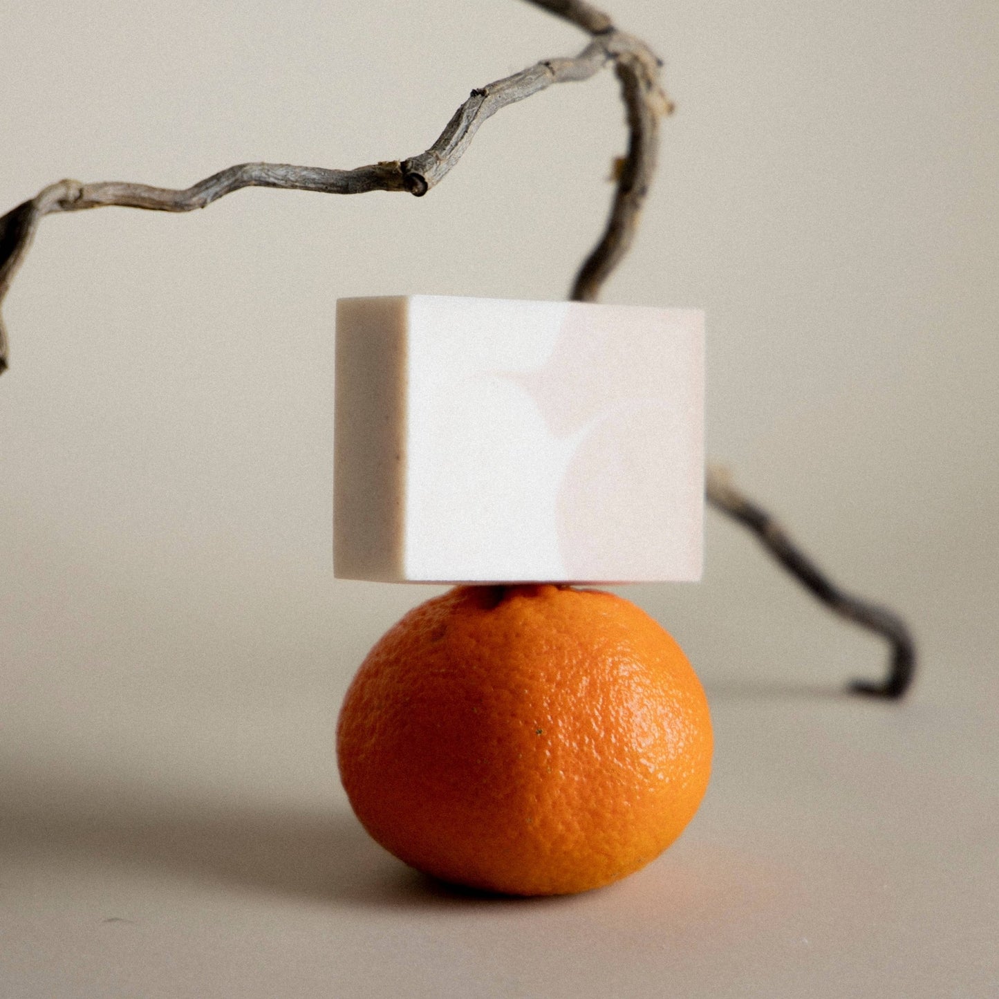 bar of soap balanced on an orange