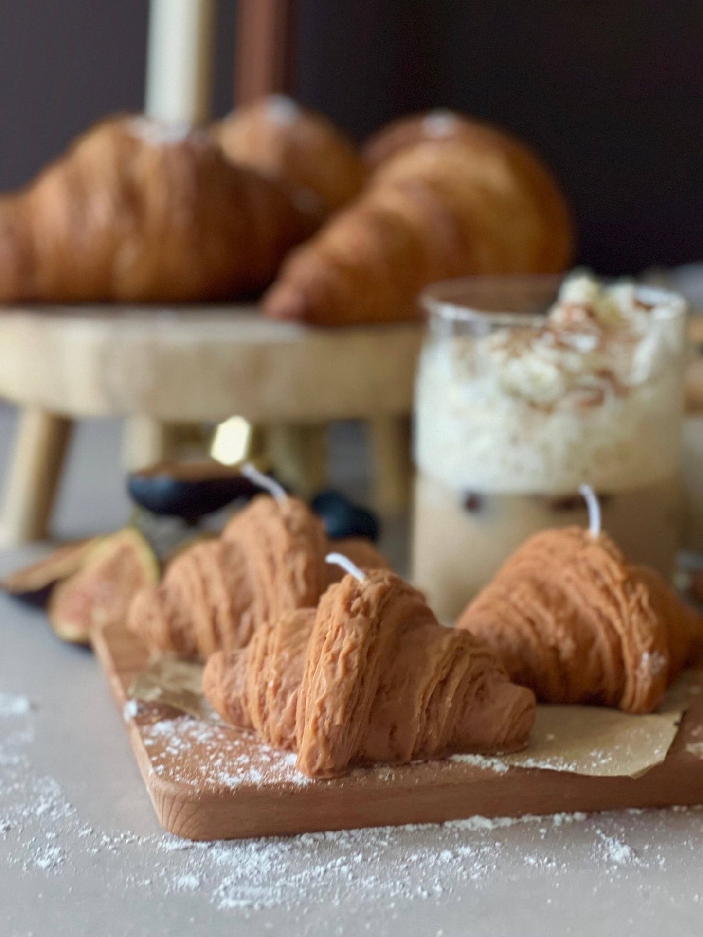 3 croissant shaped candles on a wooden board