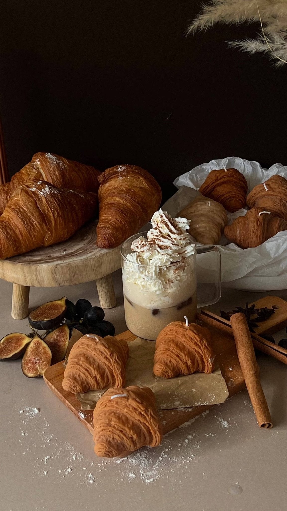 croissant shaped cinnamon candles styled in a bakery set up