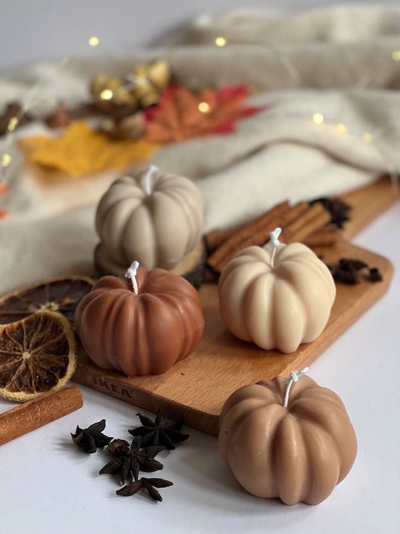 beown pumpkin candles on a wooden board